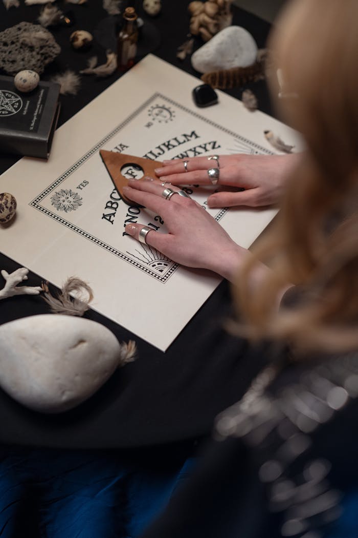 Person Using a Board with Letters on the Table